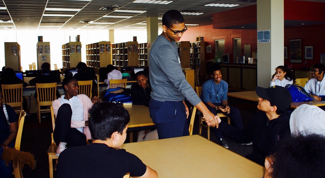 Anthony Price in a library with other school students
